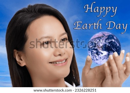 Asian woman celebrating Earth Day isolated on a blue sky background with copy space