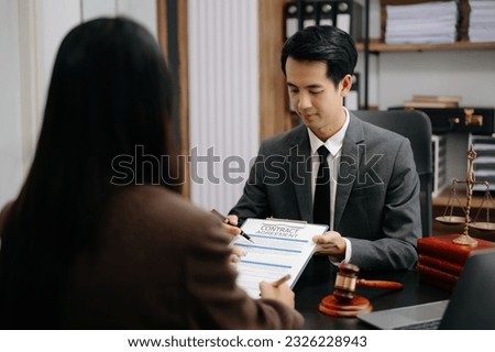 Asian Business law concept, Lawyer business lawyers are consulting lawyers for women entrepreneurs to file copyright lawsuit with laptop and tablet at modern office 
