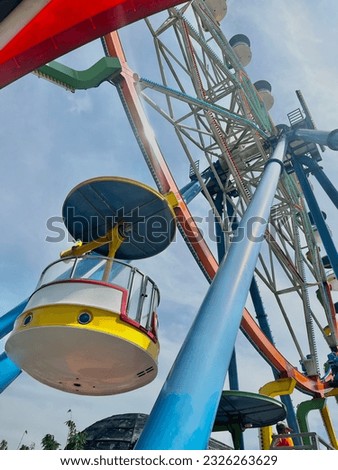interesting ferris wheel in the photo from below which makes it look even more attractive.