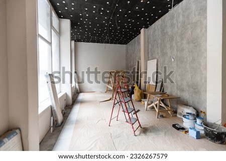 Interior of apartment with materials during on the renovation and construction, remodel wall from gypsum plasterboard or drywall Royalty-Free Stock Photo #2326267579