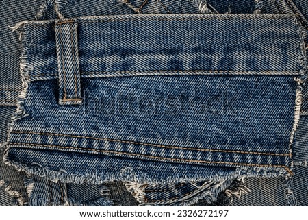 Denim blue jeans band frame. Ripped denim fabric. Destroyed torn denim blue jeans patches background. Recycle old jeans denim pieces concept. Many fragments of jeans cloth.