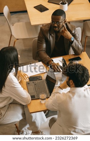 Diverse male coworkers listening to their white female colleague giving new business idea Royalty-Free Stock Photo #2326272369