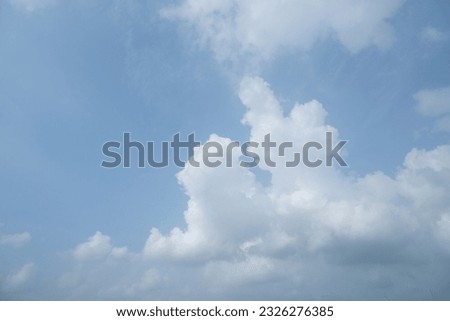 Image of a blue sky filled with clouds.