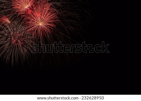 Huge colorful fireworks against the night sky, on black, with copy space