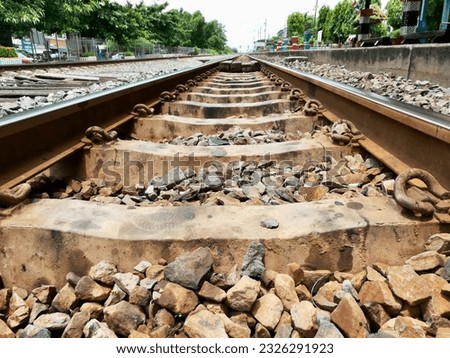a photography of a train track with rocks and gravel on the tracks, there is a train track that has been completely destroyed by rocks