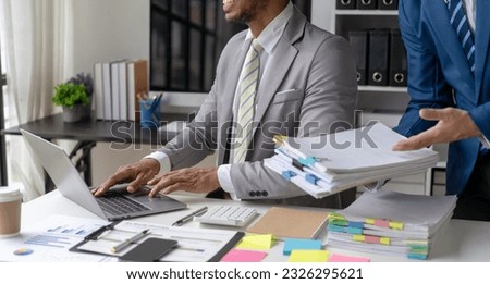 Businessman working in financial accounting with piles of documents on the desk at home work from home concept, business report, pile of unfinished paperwork	 Royalty-Free Stock Photo #2326295621
