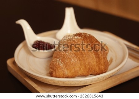 Croissant bread served in a white plate