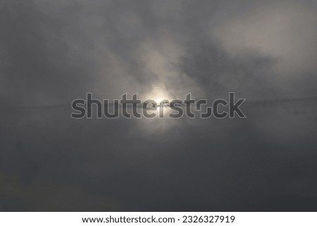Cloudy sky with sun in the center