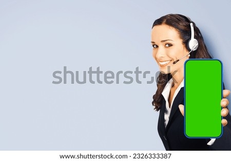 Ad concept photo - contact operator show smartphone cell phone mobile green chroma key mockup screen isolated gray background. Consulting assistance help service call center. Caller worker. App. Skype