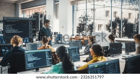 Teacher Giving Lesson to Diverse Multiethnic Group of Female and Male Students in College Room. Class Learning About Computer Science and Software Development. Lecturer Shares Knowledge with Scholars Royalty-Free Stock Photo #2326351797
