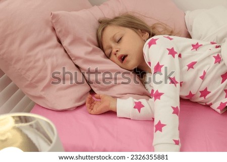 Little girl snoring while sleeping in bed Royalty-Free Stock Photo #2326355881