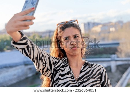 Funny latin woman taking selfie for social media