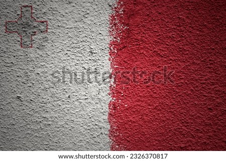 colorful painted big national flag of malta on a massive old cracked wall
