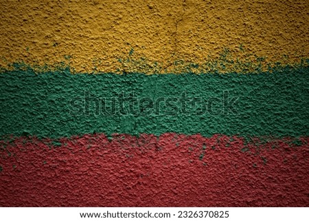 colorful painted big national flag of lithuania on a massive old cracked wall