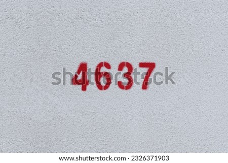Red Number 4637 on the white wall. Spray paint.
