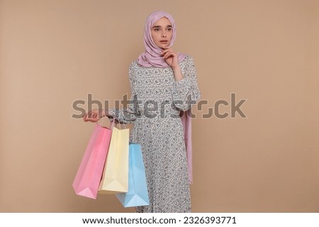Cute young muslim woman with shopping bags