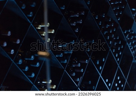 A spacious wine cellar filled with a variety of bottles of wine Royalty-Free Stock Photo #2326396025