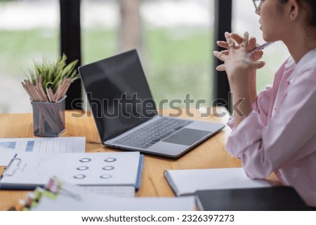 Business asian women working on laptop in office, calculating income-expenditure and analyzing real estate investment data, Accounting Financial and tax systems concept.