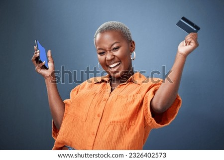 Winner, phone and credit card with a black woman online shopping in studio on a gray background. Mobile, ecommerce and wow with a happy young female shopper in celebration of deal or sale success Royalty-Free Stock Photo #2326402573