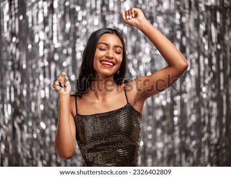 Dance, celebration and happy Indian woman in studio for party, birthday or disco against a silver background. Smile, freedom and female person dancing at an event or festival with good mood or vibes Royalty-Free Stock Photo #2326402809