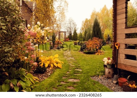 beautiful autumn garden view with curvy lawn pathway. Private natural country garden in october Royalty-Free Stock Photo #2326408265