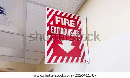 Fire extinguisher and sign, representing safety and preparedness. Symbolic of protection against fire hazards and emergency response