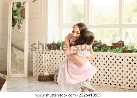 little girl  runs hug her mother, kid rejoice over , happy family