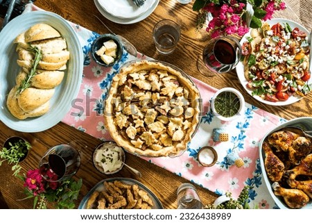 Abundant late summer spread with cardamom apple pie with leaf cut-outs, paprika chicken, basil tomato salad, garlic challah and fried okra.