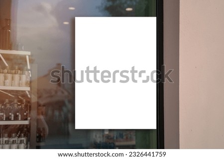 White vertical banner fixed on pharmacy or cosmetics store window glass outside