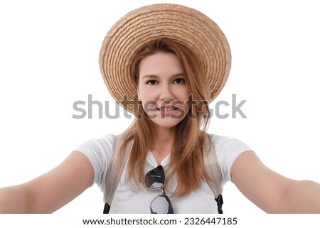 Beautiful woman in straw hat taking selfie on white background