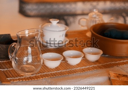 A selective focus of Chinese tea dishes on the straw placemats with blurred background