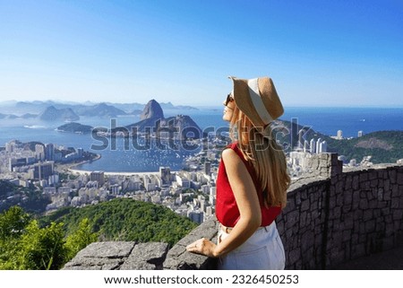Fashion tourist woman on terrace in Rio de Janeiro with the famous Guanabara bay and the cityscape of Rio de Janerio, Brazil Royalty-Free Stock Photo #2326450253