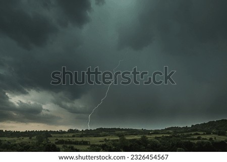 Storm clouds and lightning above the countryside