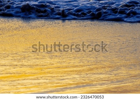 Beautiful yellow. Sunset time. Seascape background. Sunlight reflection in water. Magnificent scenery. Beautiful nature. Copy space. Selective Focus.