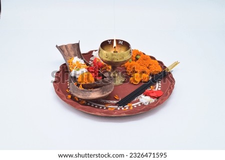 DECORATIVE PUJA THALI WITH KOSHA KHUSI,DIYA,MARIGOLD FLOWER AND OTHER FLOWERS PETALS ISOLATED ON WHITE WITH SELECTIVE FOCUS. Royalty-Free Stock Photo #2326471595