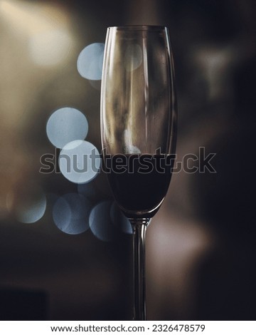 A closeup shot of the glass of the red wine with bokeh background