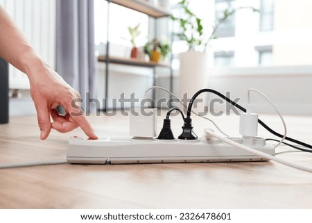Electrical plug in outlet socket at home. Energy efficiency concept Royalty-Free Stock Photo #2326478601