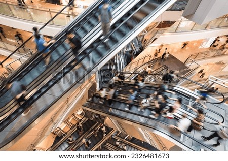 Motion blur Asian people customer transport on escalator at urban shopping mall in Hong Kong. Department store business, financial economy, Asia city life, tourist traveler lifestyle. High angle view
