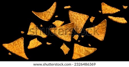 Falling corn chips, hot Mexican nachos isolated on black background Royalty-Free Stock Photo #2326486369