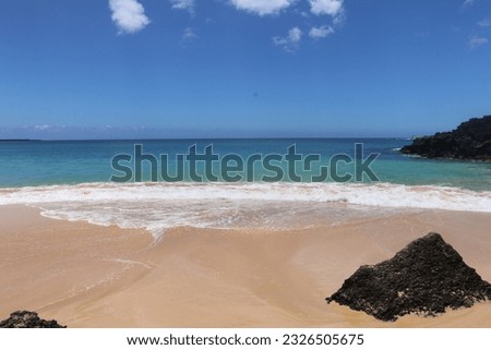 Sandy beach with waves breaking