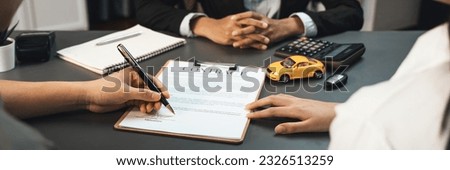 Customer client signs the contract with the agent or car dealer after successful car loan or purchasing a new car. Auto insurance and finance agreements. Prodigy