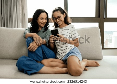 Single parenthood. Mother and daughter spending time together at home.