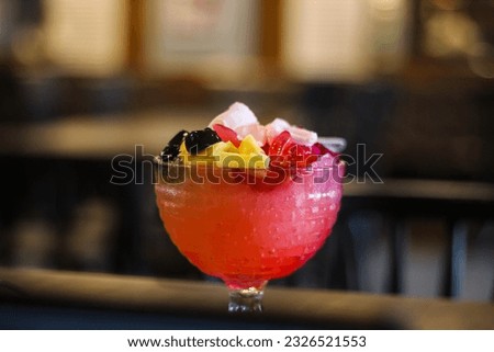 Portrait of a glass bowl filled with red fruit ice, looks delicious and refreshing