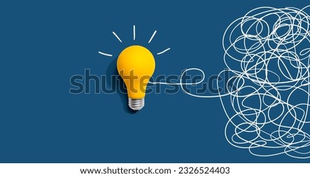 Clarifying complex ideas theme with light bulb - Flat lay Royalty-Free Stock Photo #2326524403