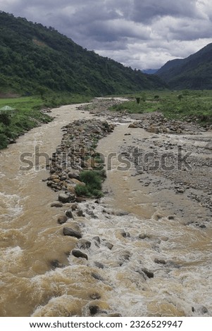beautiful river valley, flowing stream, forest and himalaya foothills of terai - dooars region. birds eye view of flowing balason river in monsoon season at dudhia, darjeeling in west bengal, india Royalty-Free Stock Photo #2326529947