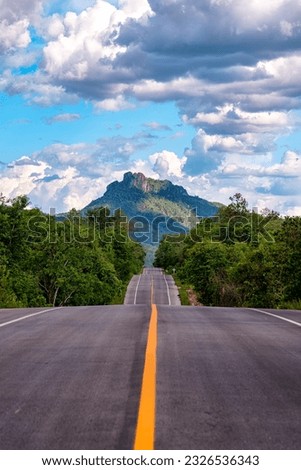 Beautiful Road Route Number 1252 Jae Son – Ban Mae Chaem, Lampang, Thailand. A mountain in front is the location of Chaloemphrakiat Phrachomklao Rachanuson temple tourists come to take pictures