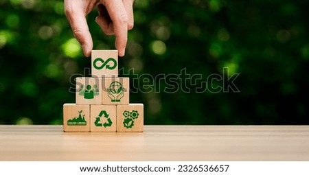 circular economy icons in wooden cubes. economic system that aims to minimize waste and maximize resource efficiency, sustainable strategies to eliminate waste and pollution for future business growth Royalty-Free Stock Photo #2326536657