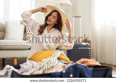 Portrait of backpacker beauty asian traveler woman packing prepare stuff and outfit clothes in suitcases travel bag luggage for summer, holiday, weekend, tourist, journey, vacation trip at home.travel Royalty-Free Stock Photo #2326550171