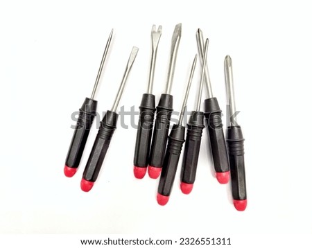 Screwdrivers set with different types on isolated white background. Philips crossedhead, flattedhead and spanner screwdrivers with black and red handle