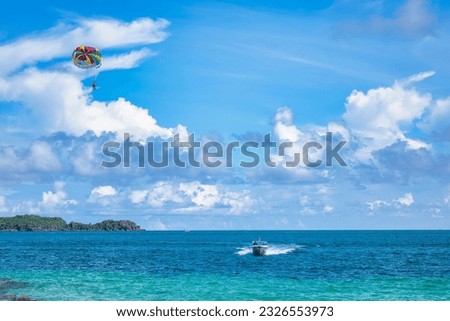 Paragliding on the sea at Hon May Rut Trong (Phu Quoc, Kien Giang, Vietnam) - one of the very attractive activities for foreign tourists